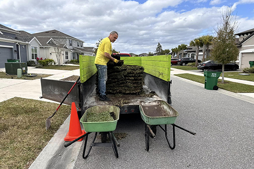 Employee Unloading Sod To Be Installed on a Residential Lawn in Wesley Chapel Florida